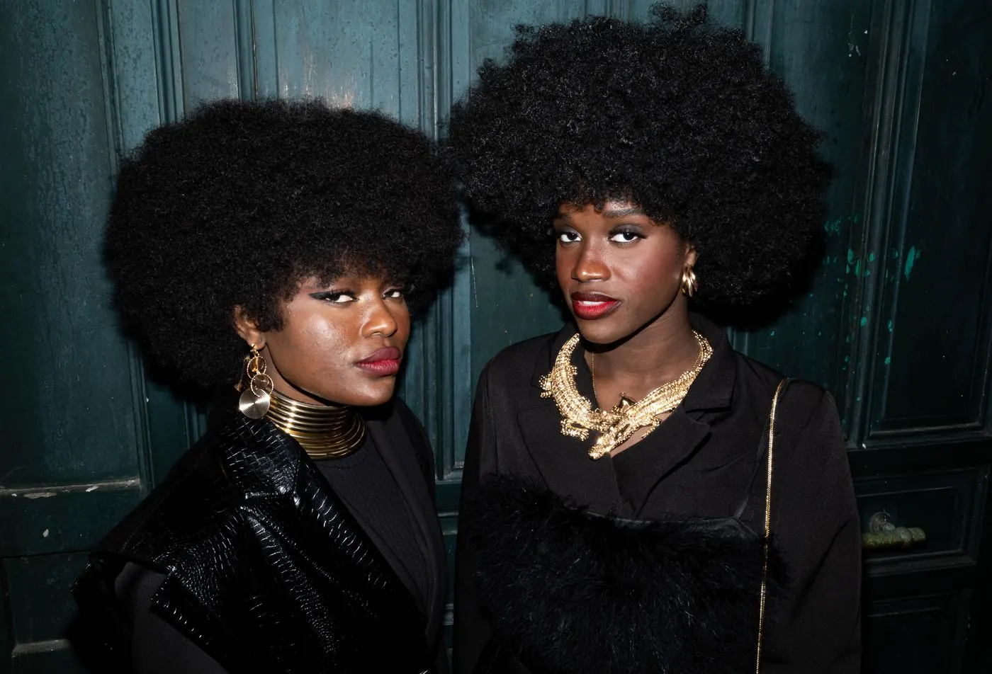 Two clients with styled afros and gold jewelry