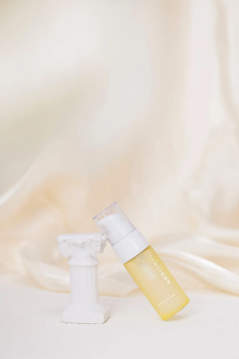 Hair treatment serum bottle on soft fabric